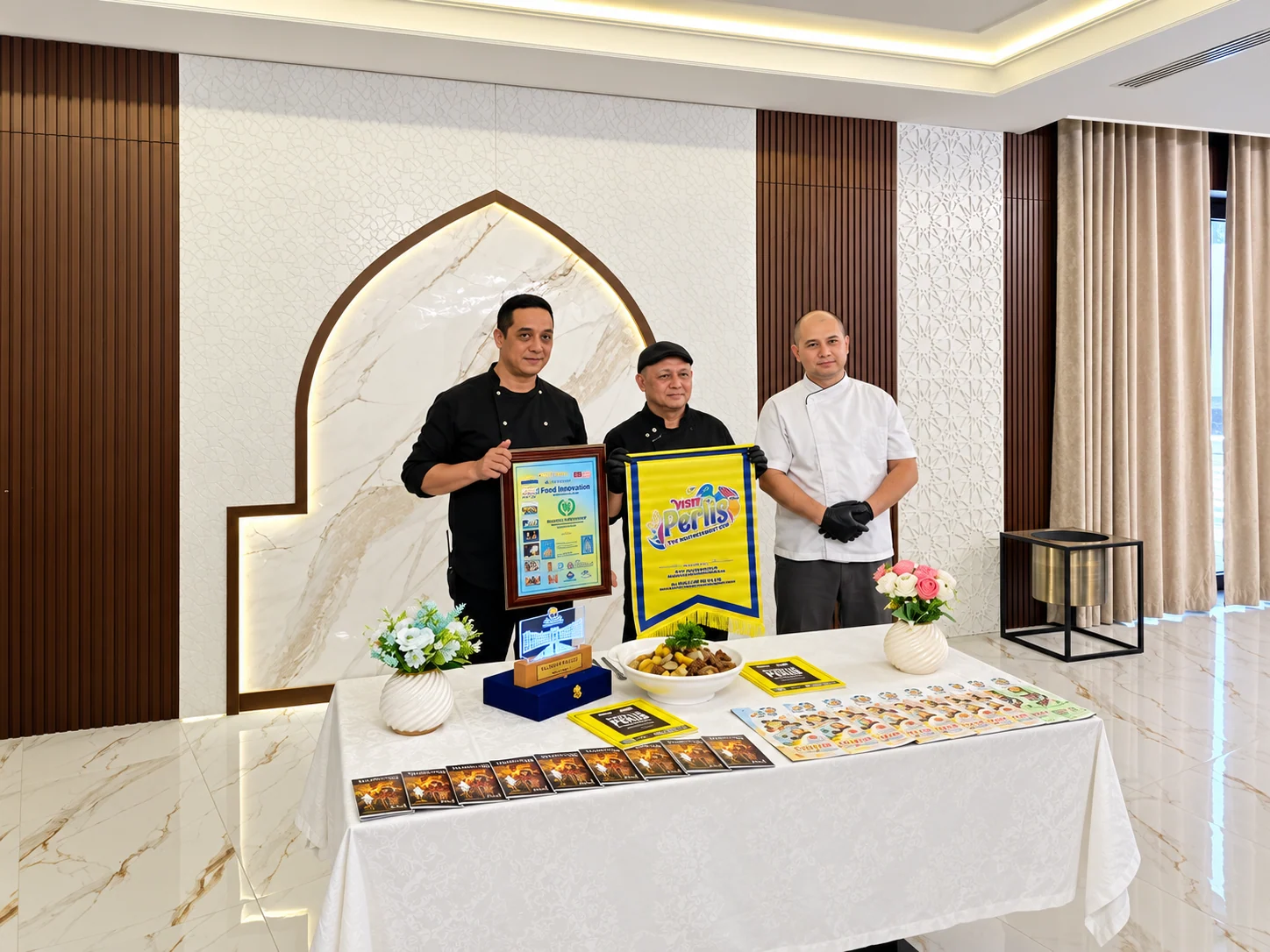 Delegation representatives with a commemorative presentation at HADITH Hotel.